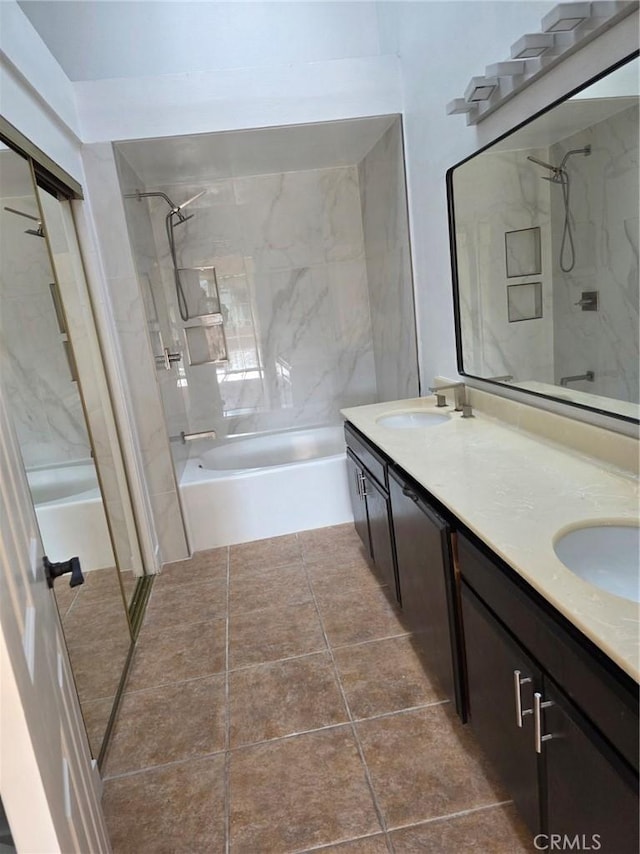 bathroom with tiled shower / bath, vanity, and tile patterned flooring