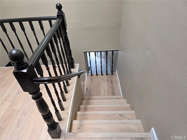 staircase featuring wood-type flooring