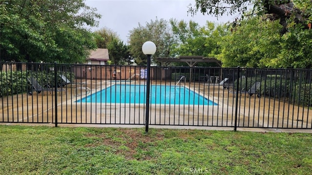 pool with a yard, a patio area, and fence