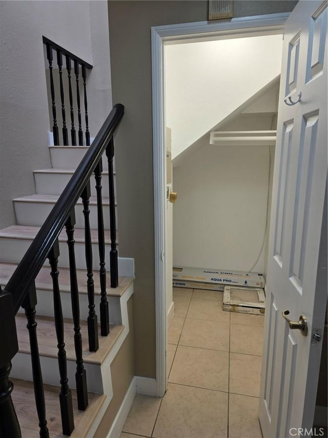 stairs featuring tile patterned floors