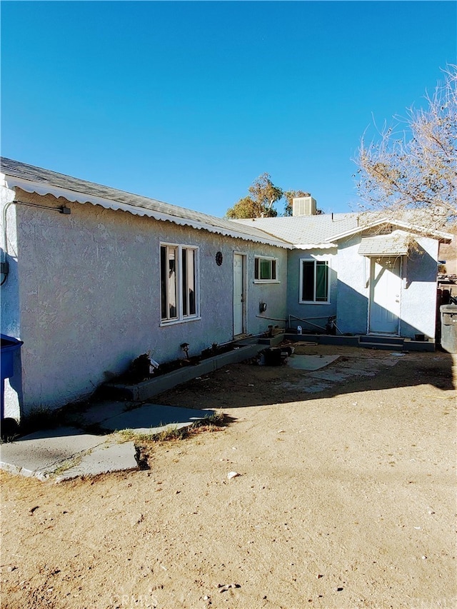 back of property featuring central AC unit