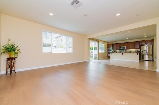 unfurnished living room featuring light wood-type flooring