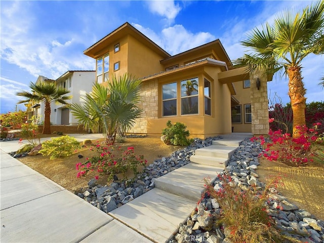 view of front of home with stone siding and stucco siding