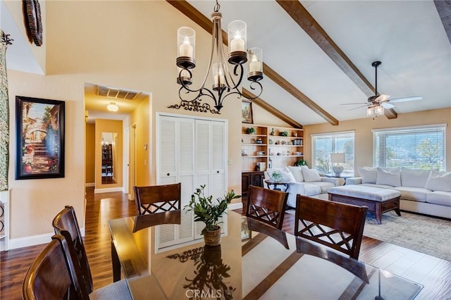 dining space with ceiling fan with notable chandelier, visible vents, baseboards, beamed ceiling, and dark wood finished floors