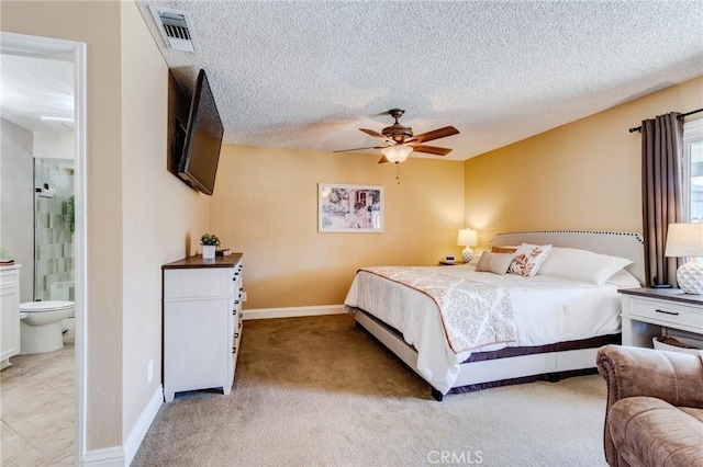 bedroom with baseboards, visible vents, a textured ceiling, and light colored carpet