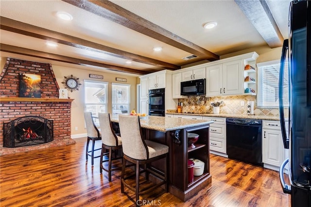 kitchen with black appliances, visible vents, open shelves, and dark wood finished floors