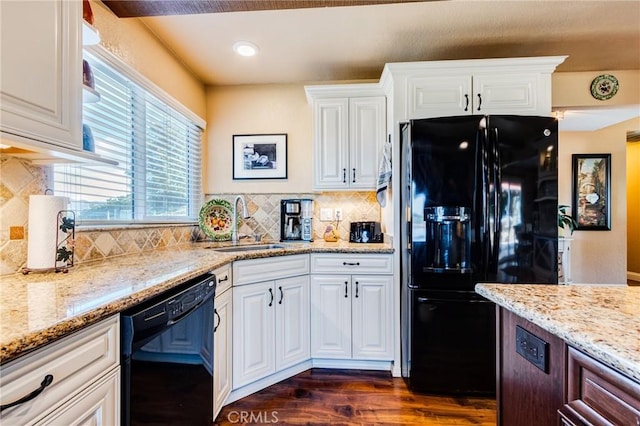 kitchen with light stone counters, dark wood-style flooring, white cabinets, a sink, and black appliances