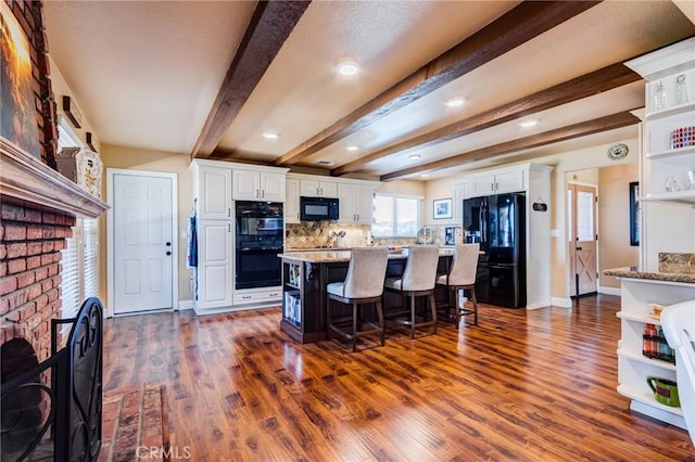 kitchen with white cabinetry, a fireplace, black appliances, and open shelves