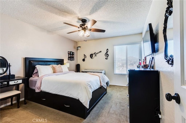 carpeted bedroom featuring a textured ceiling, a ceiling fan, and baseboards