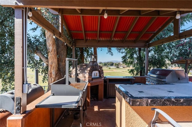 view of patio / terrace featuring a gazebo, area for grilling, and a grill