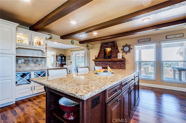 kitchen with dark wood-style floors, light stone countertops, white cabinets, and open shelves