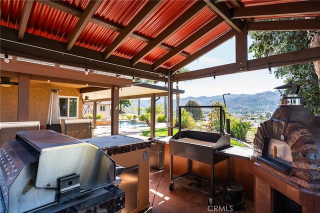 view of patio / terrace featuring exterior kitchen and a mountain view