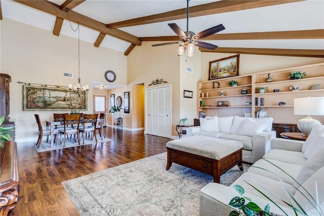 living room featuring lofted ceiling with beams, ceiling fan with notable chandelier, wood finished floors, and baseboards