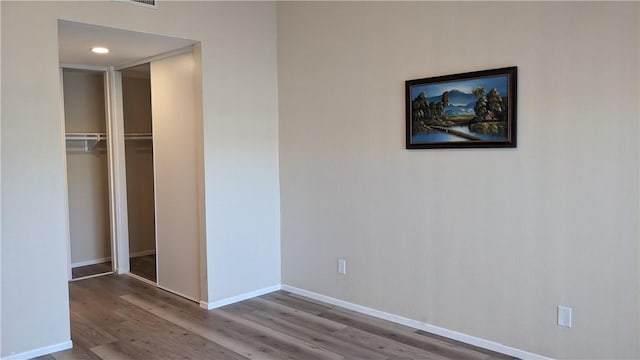 unfurnished bedroom with wood-type flooring and a closet