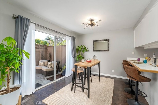 dining room with dark wood finished floors and baseboards