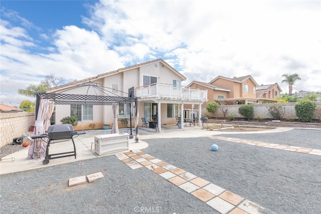 rear view of house with a patio, a gazebo, and a balcony