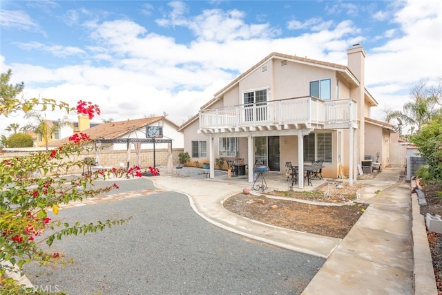 rear view of house featuring a patio and cooling unit