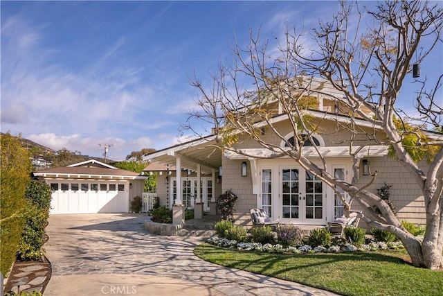 view of front of home featuring a front lawn and french doors