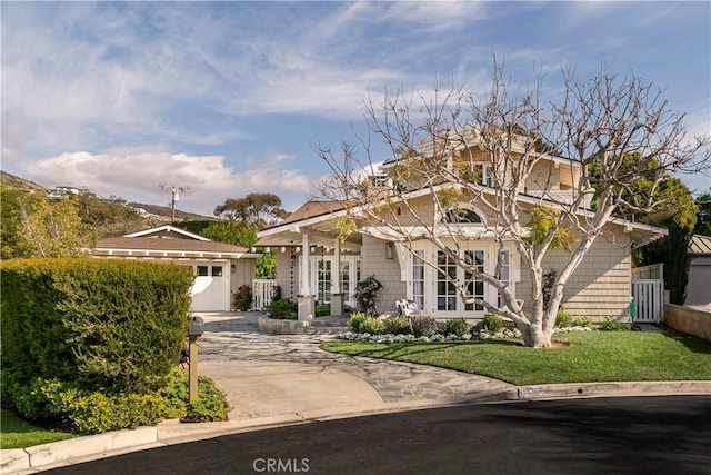 view of front of property with a front yard and french doors