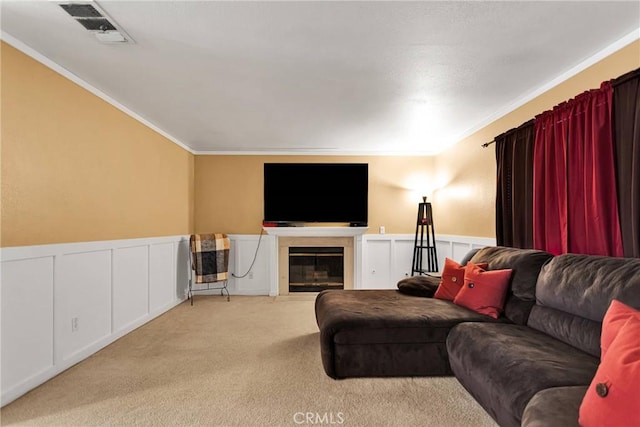 living room featuring ornamental molding and light carpet