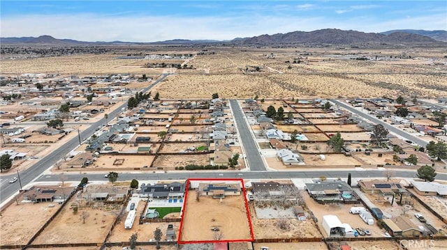 birds eye view of property featuring a mountain view