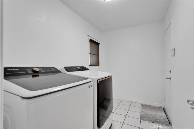 laundry area featuring light tile patterned floors and washer and dryer