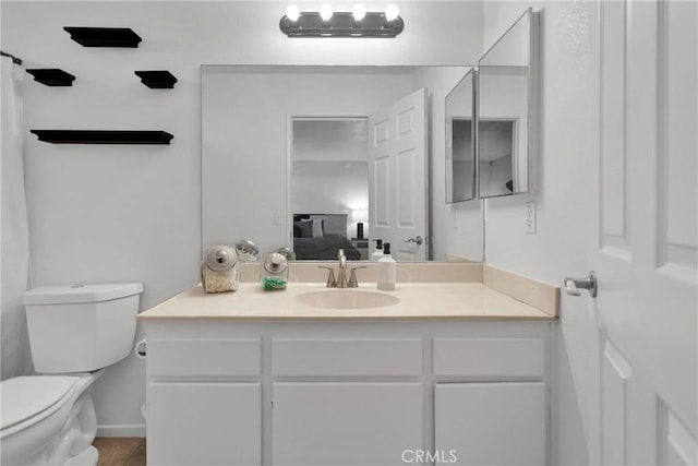 bathroom featuring vanity, tile patterned floors, and toilet