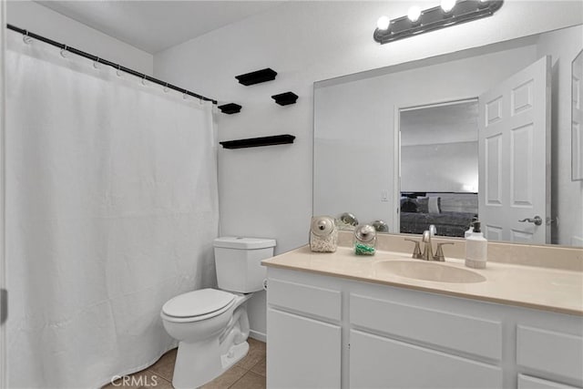 bathroom with vanity, tile patterned floors, and toilet