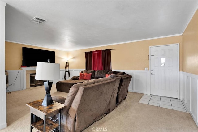 carpeted living room featuring ornamental molding