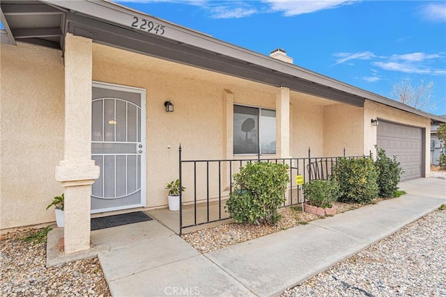 property entrance with a garage and a porch