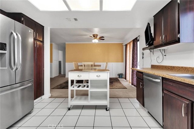 kitchen with dark brown cabinets, ceiling fan, appliances with stainless steel finishes, and light carpet