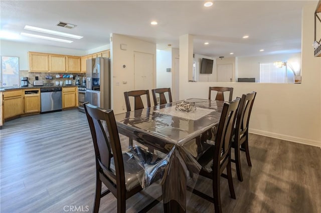 dining room with dark hardwood / wood-style flooring