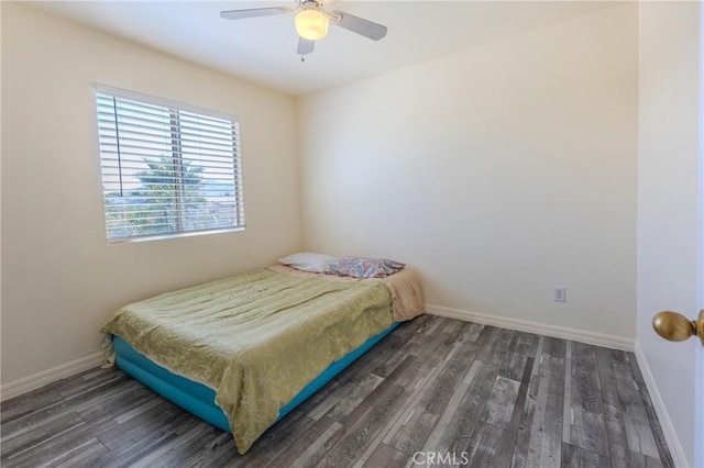 bedroom with dark wood-type flooring and ceiling fan