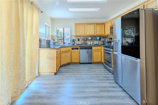 kitchen featuring tasteful backsplash, sink, light brown cabinetry, and appliances with stainless steel finishes