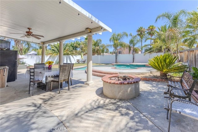 view of patio with a fenced in pool, ceiling fan, and an outdoor fire pit