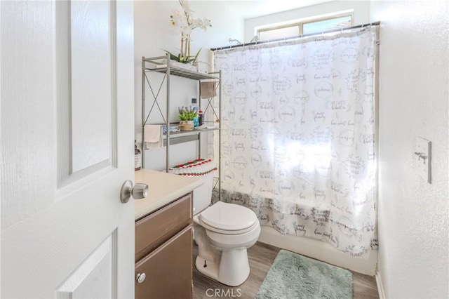 full bathroom featuring vanity, wood-type flooring, shower / bath combination with curtain, and toilet