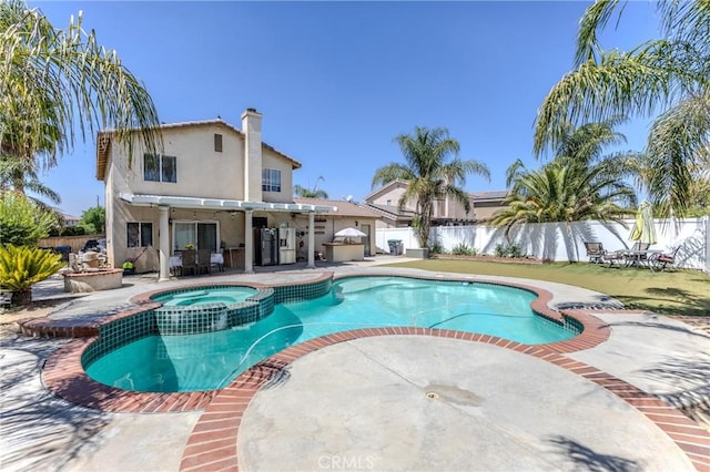 view of swimming pool featuring an in ground hot tub and a patio