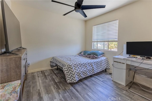 bedroom featuring dark hardwood / wood-style floors and ceiling fan