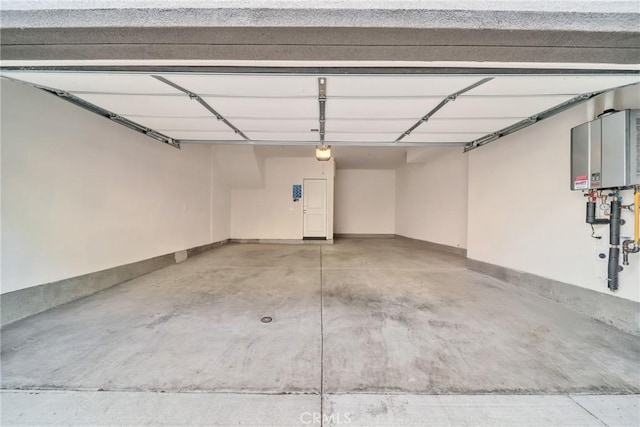 garage with tankless water heater and a garage door opener