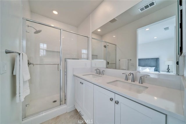 bathroom with vanity, tile patterned flooring, and a shower with door