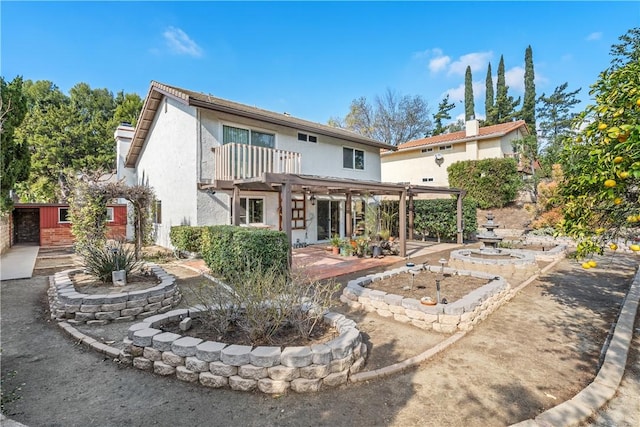 back of property featuring a pergola, a patio, and a balcony