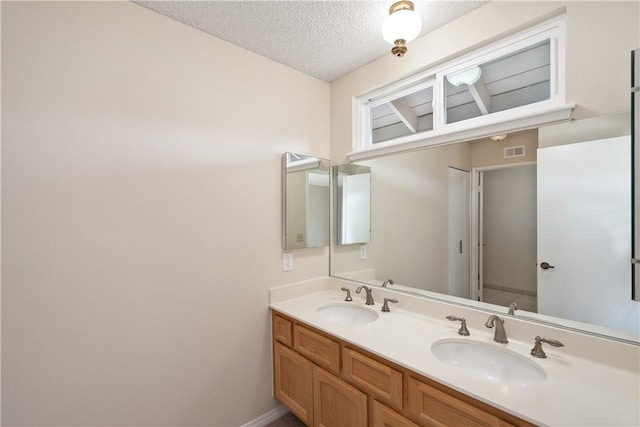 bathroom featuring vanity and a textured ceiling