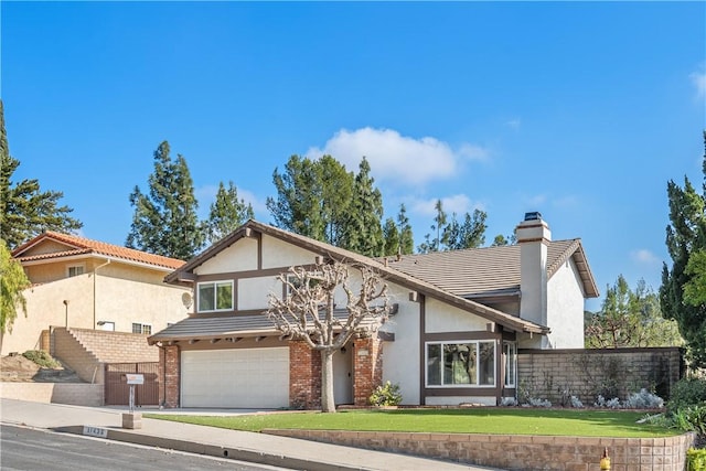 view of front of home featuring a garage and a front yard