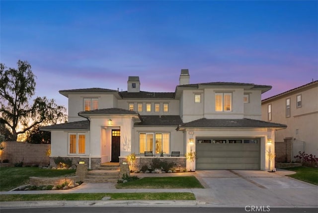 view of front of house featuring fence, concrete driveway, stucco siding, a chimney, and a garage