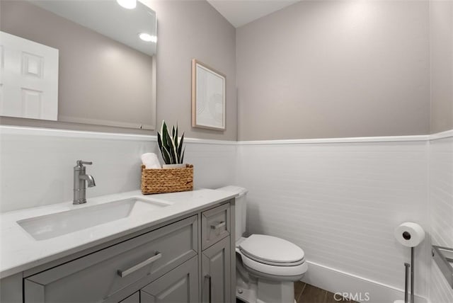 half bath featuring toilet and vanity