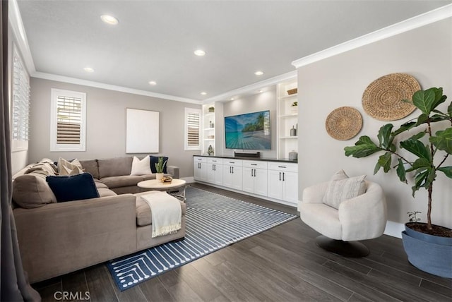 living room featuring dark wood-type flooring, recessed lighting, and ornamental molding