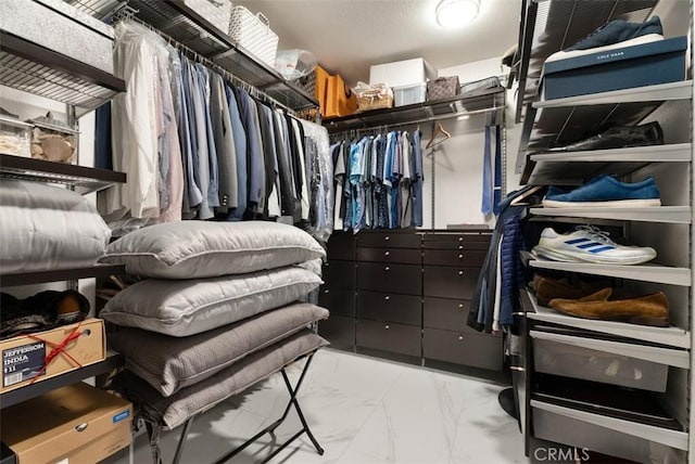 spacious closet with marble finish floor