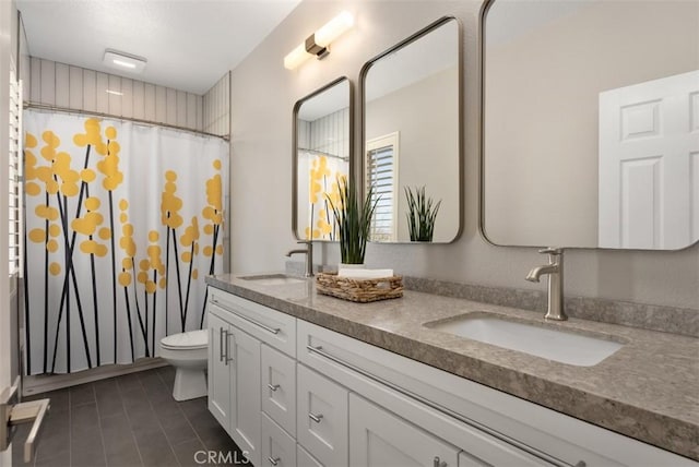 bathroom with a shower with curtain, double vanity, toilet, and a sink