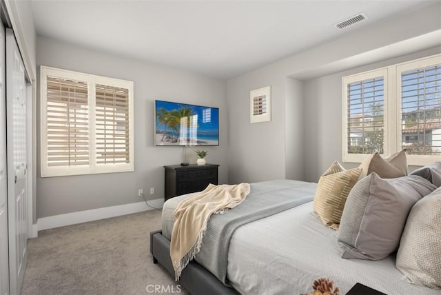 bedroom with carpet, visible vents, and baseboards