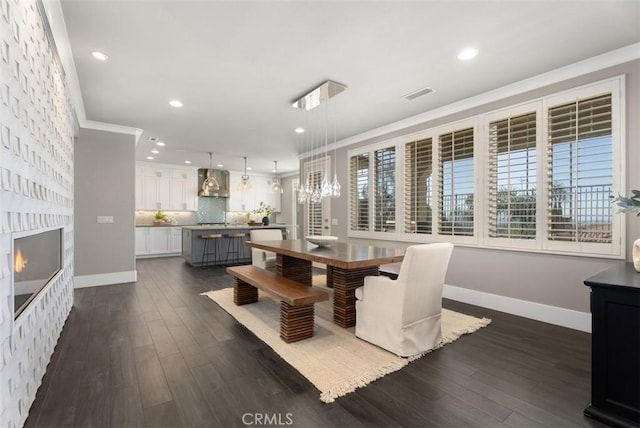 dining area with dark wood finished floors, a fireplace, visible vents, and baseboards